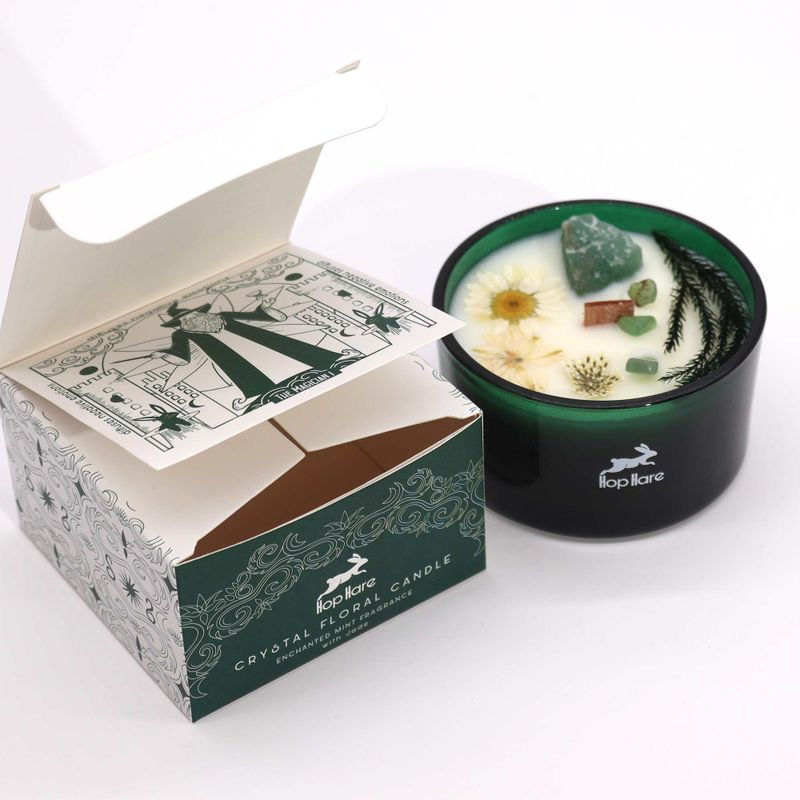 The Magician soy wax candle in a deep green glass jar