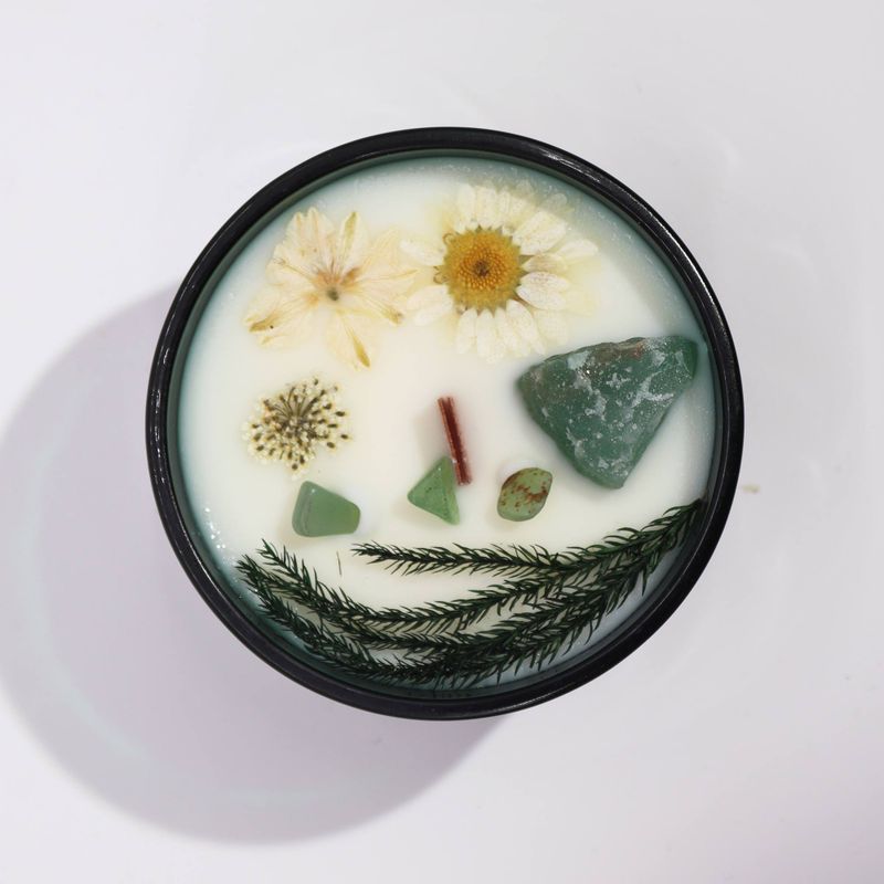 Close-up of jade and dried flowers on The Magician candle
