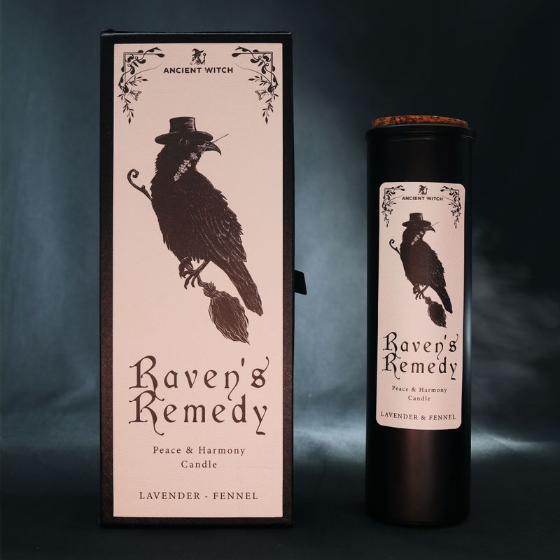 Raven's Remedy ritual candle displayed with its illustrated packaging
